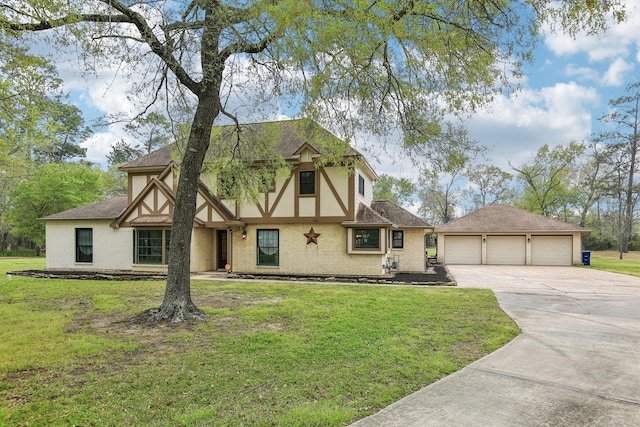 5503 Bayou Blvd, Baytown, TX 77521 - english style home featuring an outbuilding, roof with shingles, concrete driveway, a front lawn, and brick siding