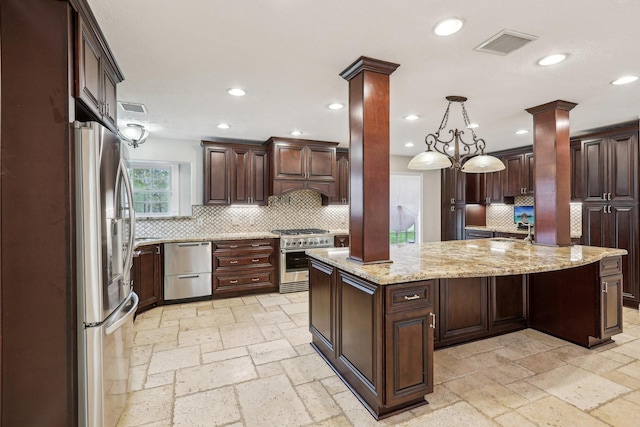 5503 Bayou Blvd, Baytown, TX 77521 - kitchen featuring stone tile floors, decorative columns, recessed lighting, and stainless steel appliances