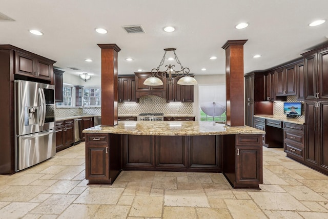 5503 Bayou Blvd, Baytown, TX 77521 - kitchen with stone tile floors, stainless steel fridge with ice dispenser, and ornate columns