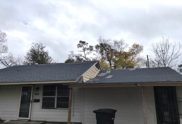 exterior space with a shingled roof