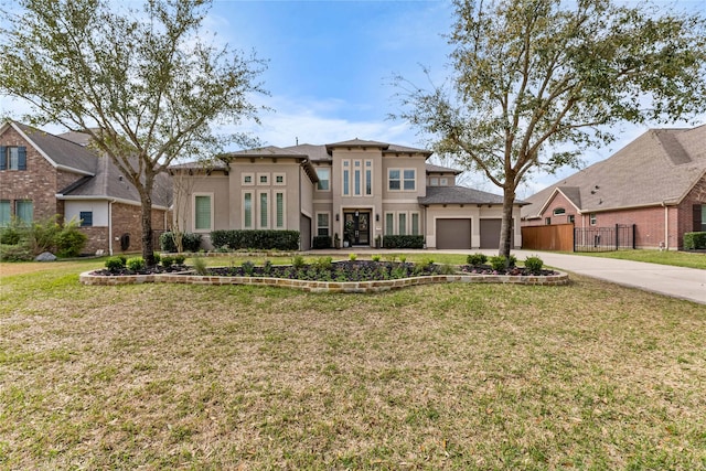 139 Ballantyne Dr, Montgomery, TX 77316 - view of front of house with stucco siding, fence, driveway, a front yard, and a garage