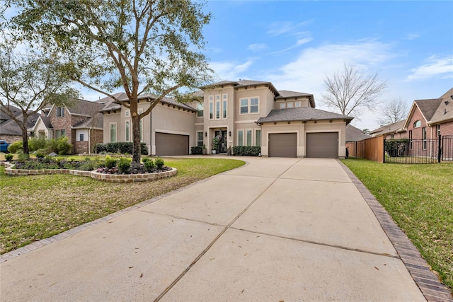 139 Ballantyne Dr, Montgomery, TX 77316 - view of front of home featuring concrete driveway, stucco siding, fence, an attached garage, and a front yard