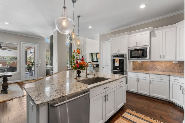 139 Ballantyne Dr, Montgomery, TX 77316 - kitchen featuring white cabinetry, stainless steel appliances, ornamental molding, backsplash, and a sink