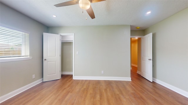 unfurnished bedroom with a textured ceiling, ceiling fan, recessed lighting, baseboards, and light wood-type flooring