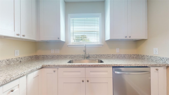 kitchen with a sink, white cabinetry, and dishwasher