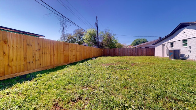 view of yard with cooling unit and a fenced backyard