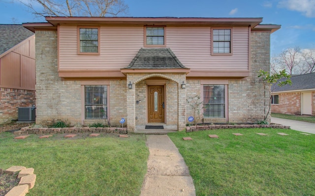 view of front of home with brick siding, central AC unit, and a front lawn