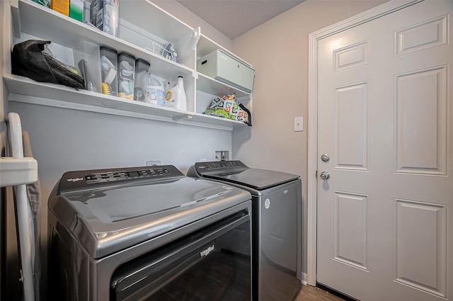 clothes washing area with laundry area and separate washer and dryer