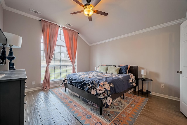 bedroom featuring lofted ceiling, visible vents, baseboards, light wood finished floors, and crown molding