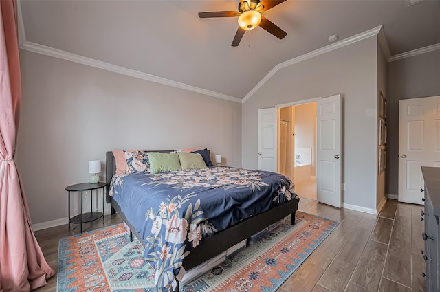 bedroom with baseboards, lofted ceiling, ceiling fan, wood finished floors, and crown molding