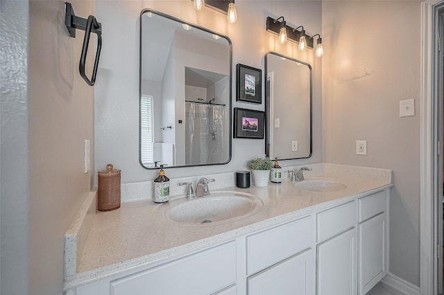 bathroom featuring curtained shower, a sink, and double vanity