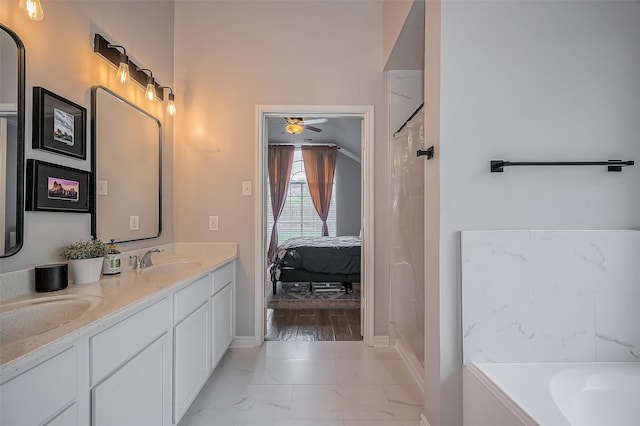 ensuite bathroom with a sink, marble finish floor, a bath, double vanity, and ensuite bath