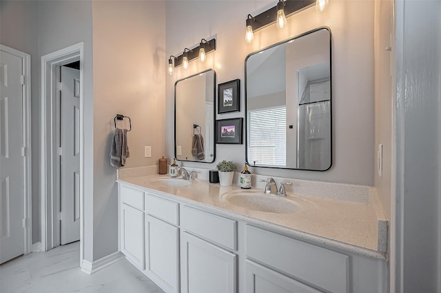 full bath with a sink, baseboards, and double vanity