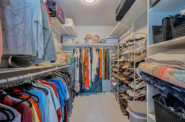 spacious closet featuring marble finish floor