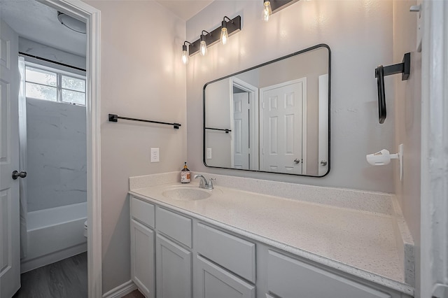 bathroom with toilet, shower / bathing tub combination, wood finished floors, and vanity