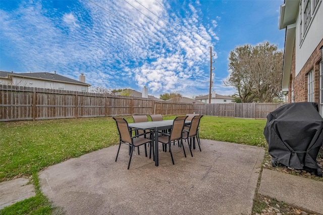 view of patio featuring outdoor dining area, a fenced backyard, and area for grilling