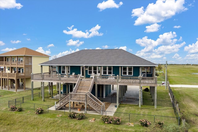 rear view of property with roof with shingles, a fenced backyard, and a yard