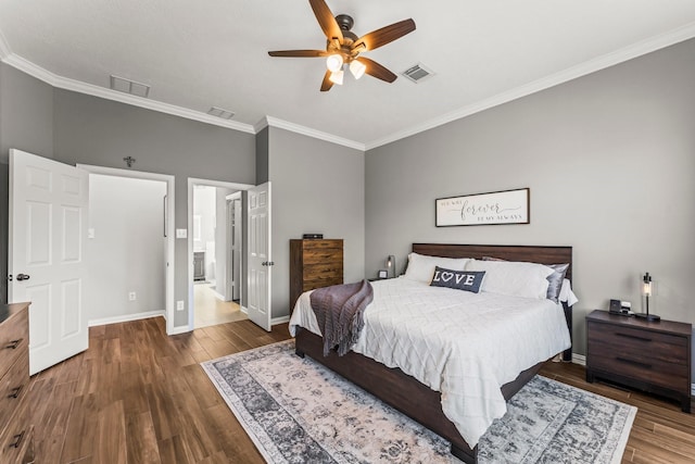 bedroom with visible vents, wood finished floors, baseboards, and ornamental molding