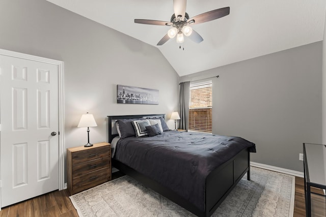 bedroom with dark wood finished floors, ceiling fan, baseboards, and vaulted ceiling