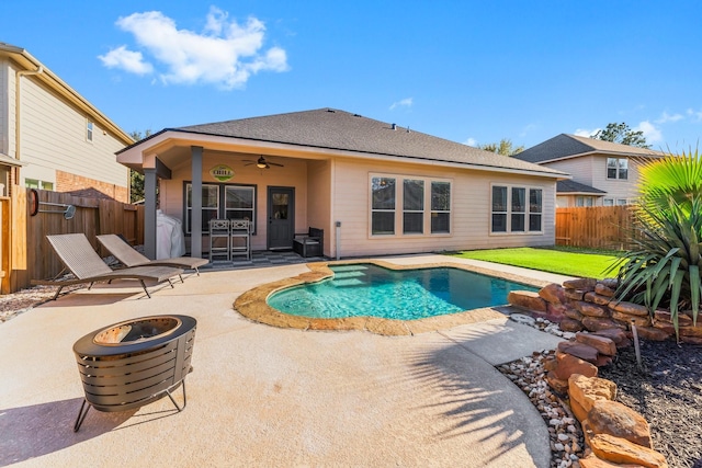 view of pool featuring a patio, a fenced backyard, an outdoor fire pit, a fenced in pool, and ceiling fan