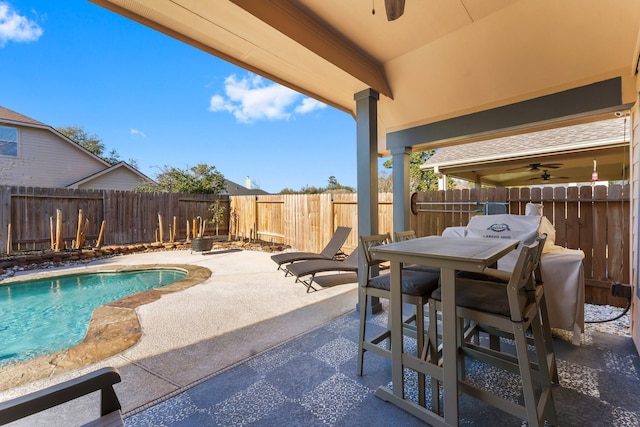 view of swimming pool featuring a fenced in pool, a patio, outdoor dining area, and a fenced backyard