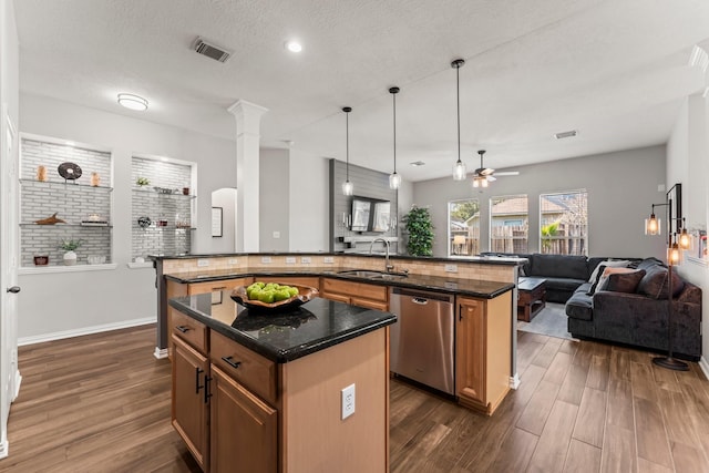 kitchen featuring a spacious island, dark wood finished floors, a sink, dishwasher, and open floor plan