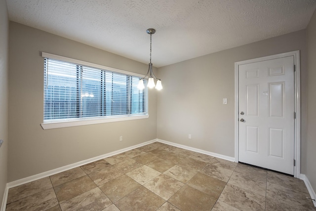 unfurnished room featuring baseboards and a textured ceiling