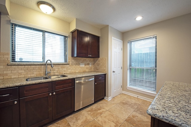 kitchen featuring a sink, backsplash, stainless steel dishwasher, dark brown cabinetry, and light tile patterned flooring