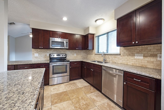 13418 Natasha Ln, Houston, TX 77015 - kitchen featuring visible vents, ceiling fan, decorative backsplash, a sink, and appliances with stainless steel finishes