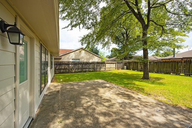 view of yard featuring a patio area and a fenced backyard