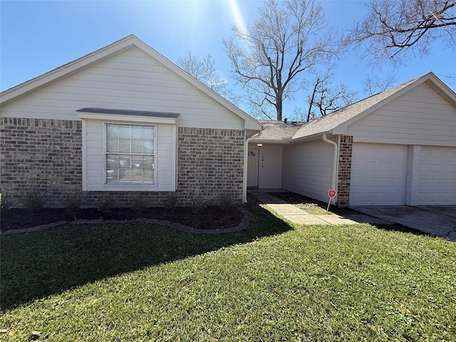 view of side of home with brick siding, a lawn, and an attached garage