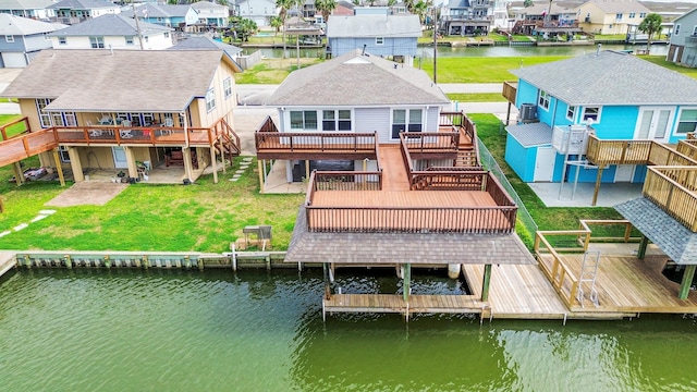 back of house with a deck with water view, a yard, stairway, a residential view, and a patio area