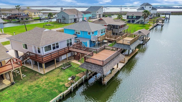 drone / aerial view featuring a residential view and a water view