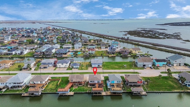 drone / aerial view with a residential view and a water view