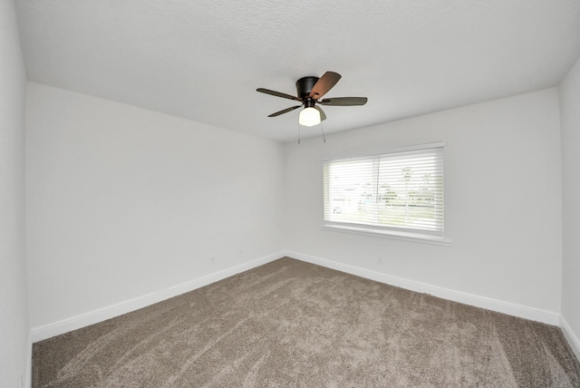 unfurnished room featuring carpet floors, baseboards, and a ceiling fan