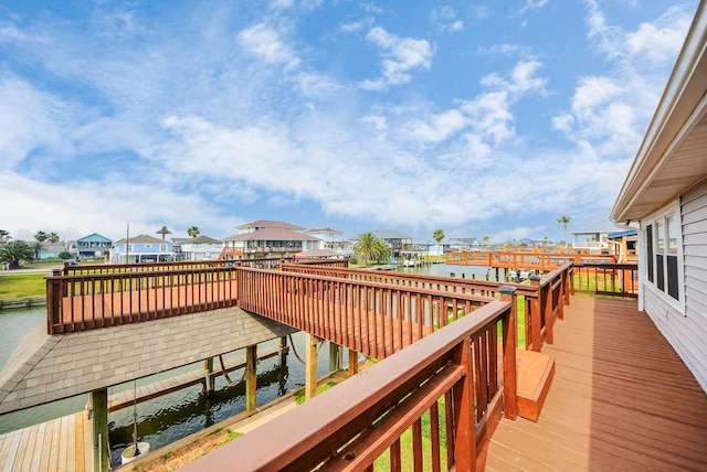 deck featuring a water view and a residential view