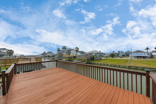 deck featuring a residential view, a water view, and fence