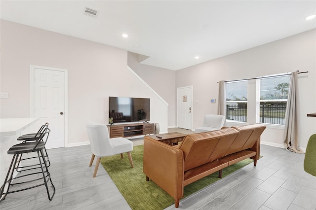 living room featuring recessed lighting, visible vents, and baseboards