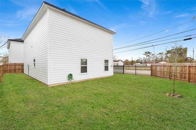 exterior space featuring a fenced backyard and a lawn