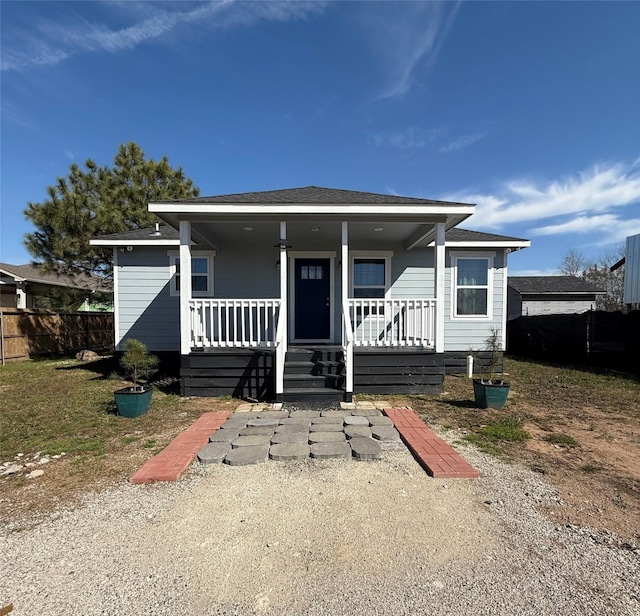 bungalow-style house featuring a porch and fence