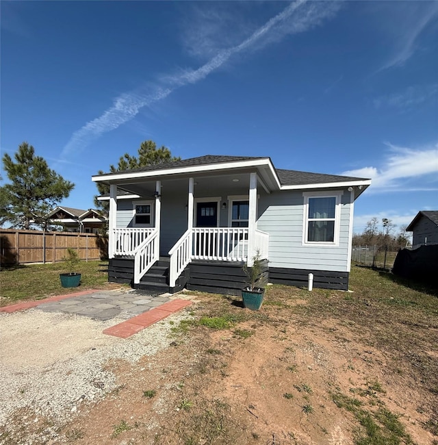 bungalow with a porch and fence