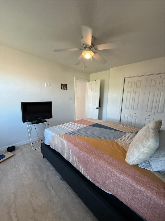 bedroom with a closet, ceiling fan, and baseboards