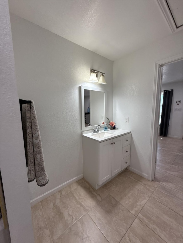 bathroom featuring vanity and baseboards