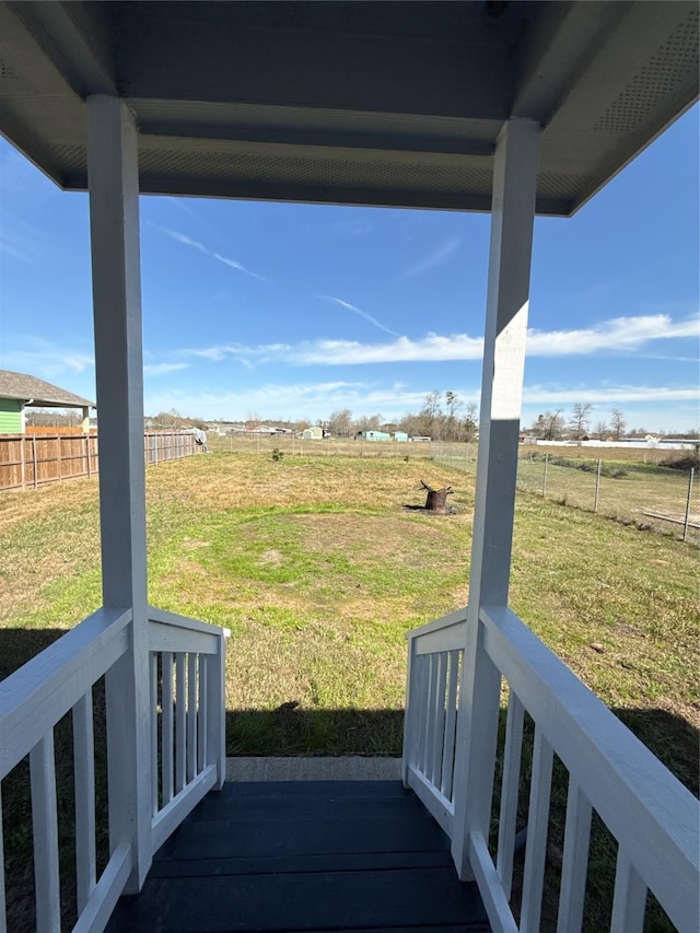 view of yard featuring a rural view and fence