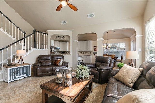 living room with stairs, visible vents, and a wealth of natural light