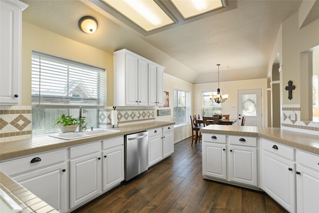 kitchen featuring dark wood-type flooring, a sink, white cabinets, dishwasher, and an inviting chandelier