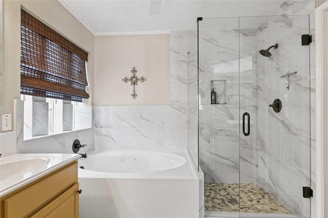 bathroom featuring tile walls, vanity, a bath, a marble finish shower, and ornamental molding