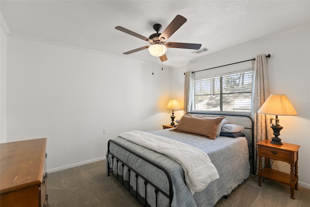 carpeted bedroom featuring a ceiling fan, visible vents, crown molding, and baseboards