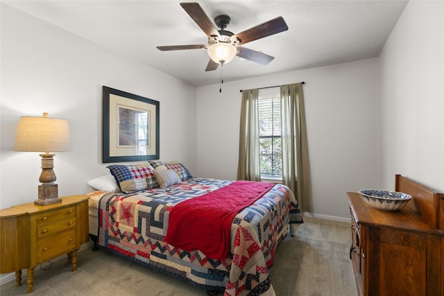 bedroom with ceiling fan, baseboards, and light colored carpet