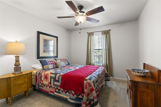 bedroom with ceiling fan, light colored carpet, and baseboards